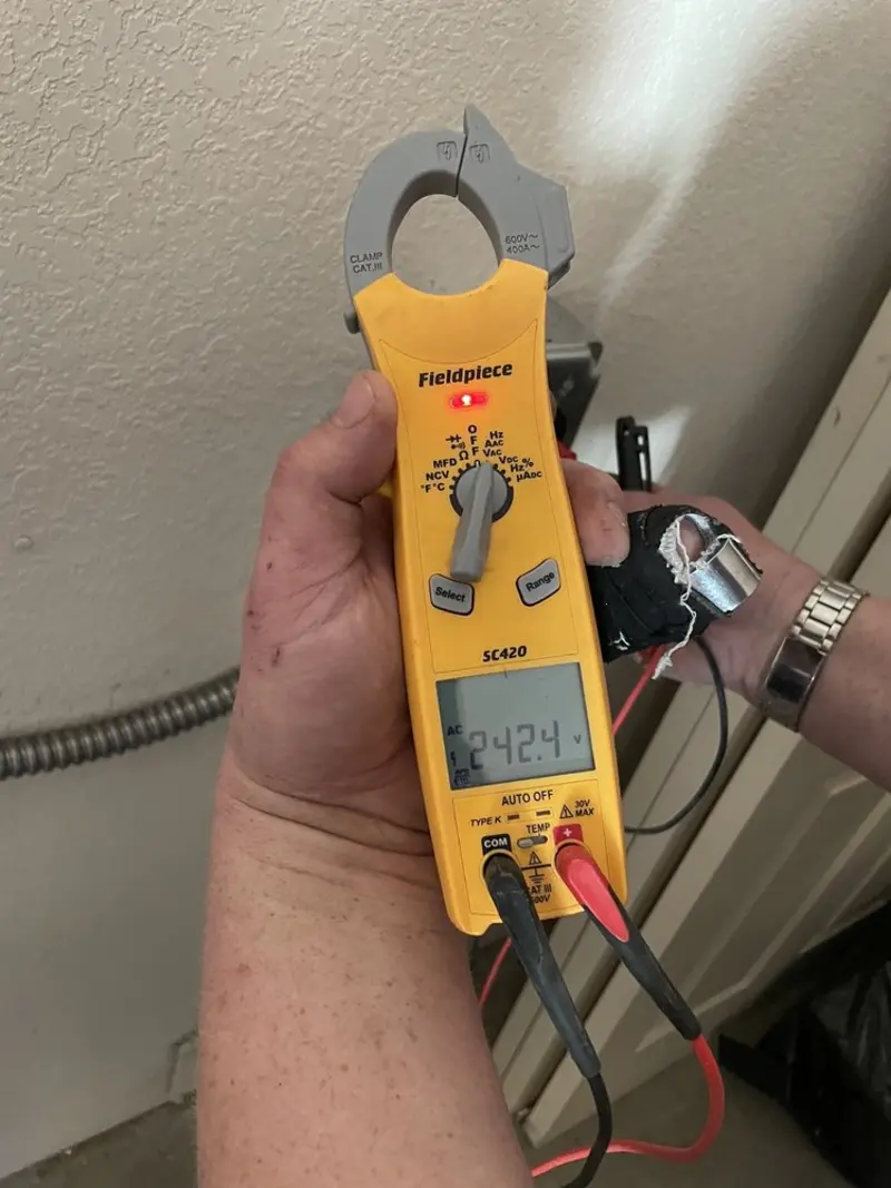 Voltage testing with clamp meter during Recessed Lighting Installation in Owasso